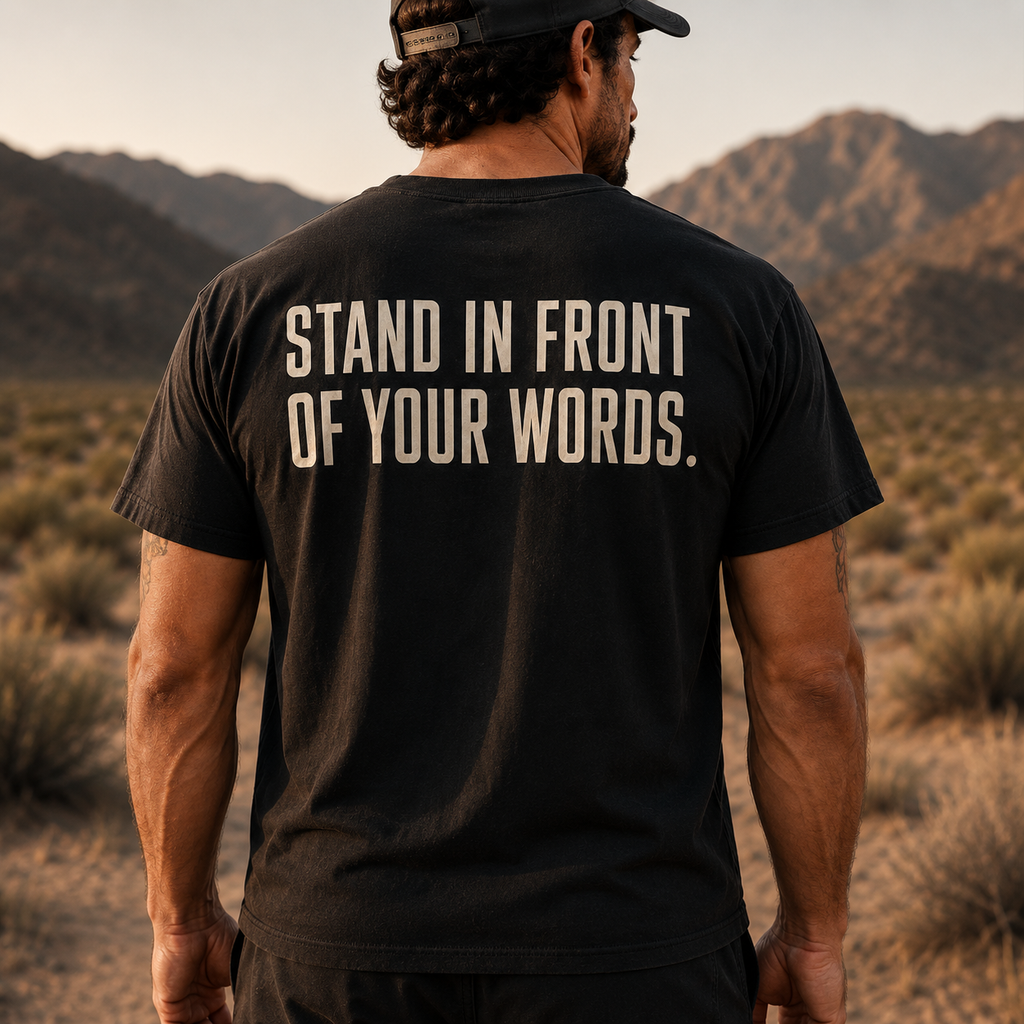 Back view of Muscular America black T-shirt featuring the phrase "STAND IN FRONT OF YOUR WORDS."